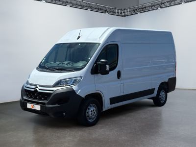 the white van is parked in a large room in a building