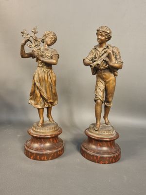 pair of antique bronze figurines of a boy and a girl
