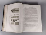 an open book with a drawing of a ship on it