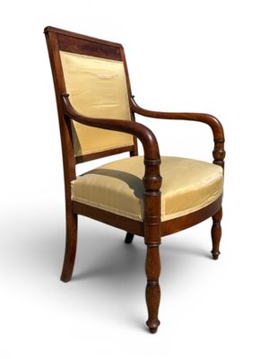 an image of a wooden chair with a beige upholstered seat