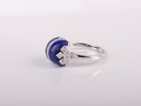 a white gold ring with a blue lapis stone and diamonds