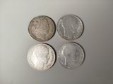 three silver coins sitting on top of a table next to each other