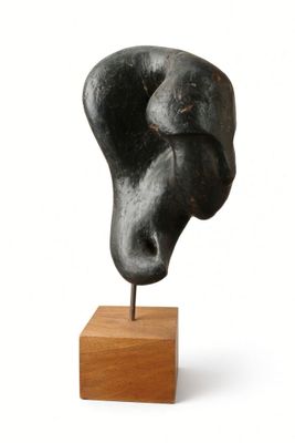 sculpture of a head on a wooden base on a white background