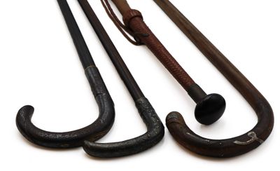 three old fashioned canes are lined up on a white surface