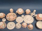 many different types of tea cups and saucers on the table