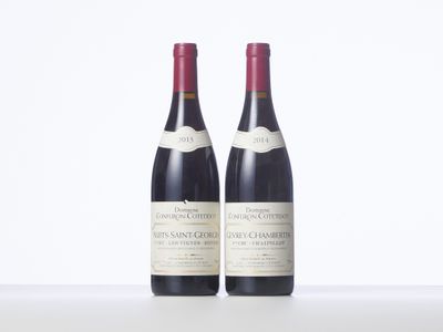two bottles of wine sitting on top of a white table