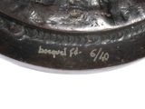 a bronze statue of a man riding a horse