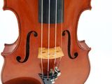 a close up of a violin on a stand