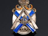 a close up of a silver and blue badge on a black surface