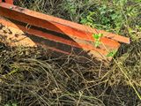 a plow that is laying on the ground in the grass