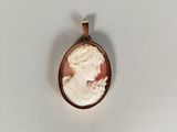 an image of a woman ' s profile in a cameo pendant