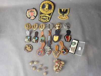 a lot of pins and badges on a table