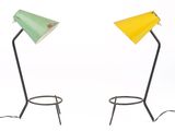 two green and yellow lamps sitting on top of a metal stand