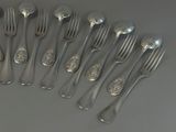 a lot of forks and spoons that are on the table