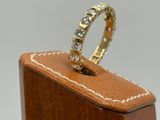 a close up of a ring on a wooden stand with a white background