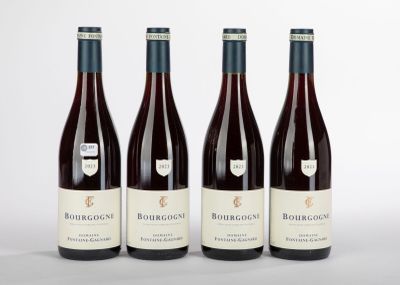 trois bouteilles de vin rouge posées côte à côte sur une table