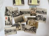 many old photos of people and buildings on the table