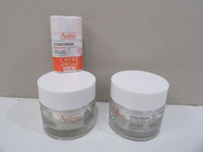 two jars of creams sitting on a counter