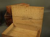 a small wooden box sitting on a table next to a small box