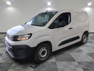 the white van is parked on a checkered tile floor