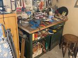 a workbench in a garage with many tools on it
