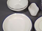 four plates and a bowl on the table