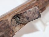 a close up of a piece of wood with a metal handle