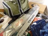 a box full of assorted items that include a backpack and a pair of jeans