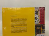 a yellow book with asian writing on it sitting on top of a table