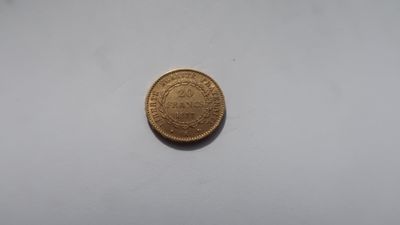 a gold coin on a white surface