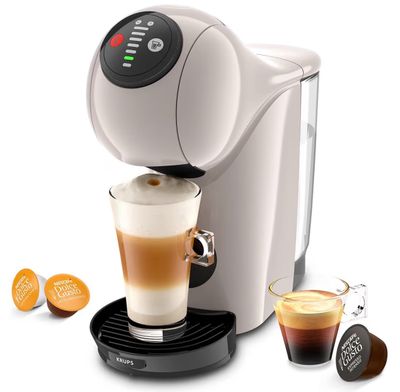 a close up of a coffee maker with a cup of coffee