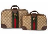 a pair of luggage bags with a green and red stripe