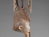 a close up of a sculpture of a bird on a stand