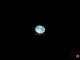a blue moon in the dark sky with a reflection on the ground