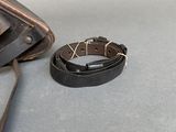 someone is using a pair of scissors to cut a piece of leather