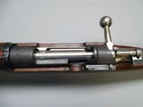 an old rifle with a wooden barrel and a metal handle
