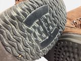 a close up of a pair of boots with a logo on the sole