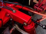 a close up of a red motorcycle with wires attached to it