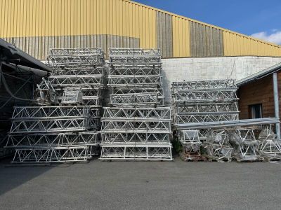 a lot of cages stacked up in front of a building