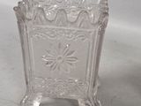 a glass vase with a flower design on it