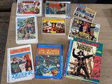 many comic books on a table with a wooden table top