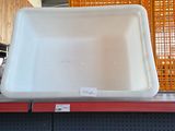 a white sink sitting on top of a shelf in a store