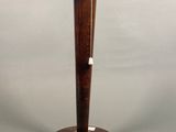 a wooden table lamp with a black shade on top of it