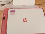a pink and white hp printer sitting on a table