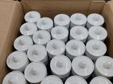 a box full of white candles sitting on a table