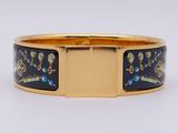a close up of a gold bracelet with a blue and yellow design