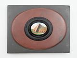 a picture of a picture of a building through a hole in the wall