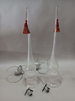 pair of clear glass lamps with red lampshads on a white background