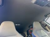 two seats in the back of a car with a remote control