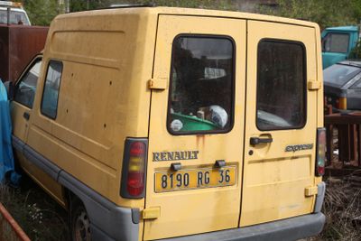 a yellow van that is parked in the grass